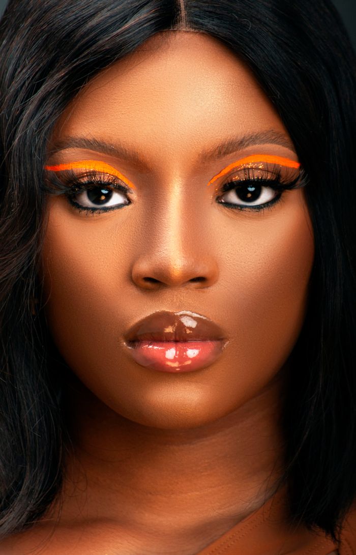 Close-up portrait capturing the bold and elegant makeup of a woman.